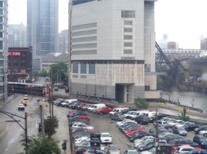 West of the Loop with the North Branch of the Chicago River on the right and a Metra train on the left.