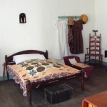 Grant took the trunk at the foot of the bed to West Point with him. The white garment on the wall belonged to his mother.